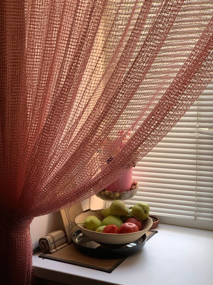 services-01 A sunlight-drenched window with pink curtains and a bowl of fresh fruits.
